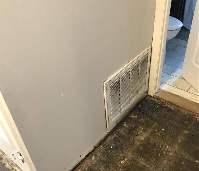 wall with heating vent damaged by water