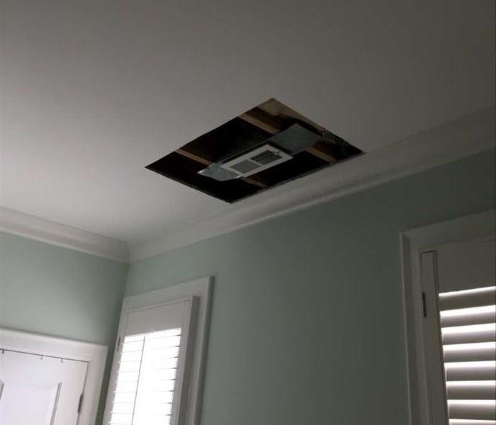hole cut in ceiling that was damaged by water