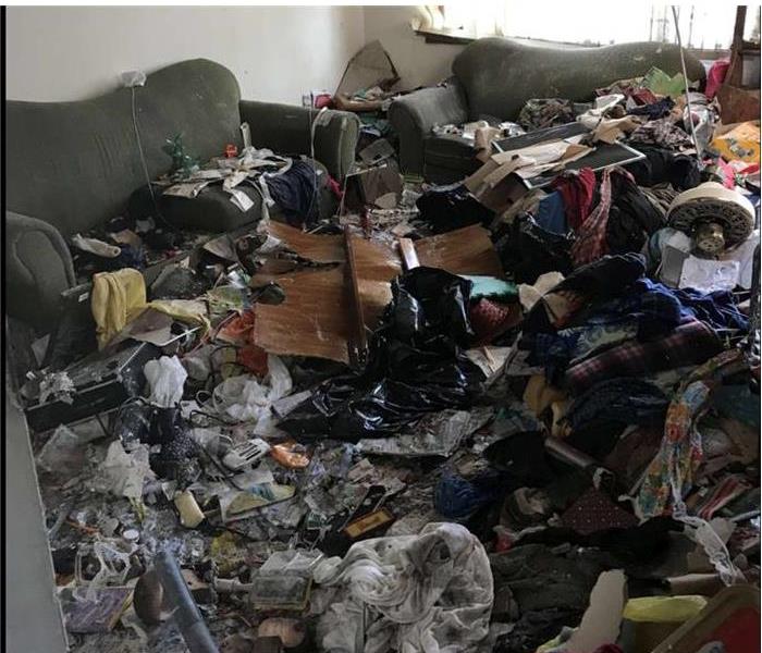 room full of hoarding debris, no floor to be seen