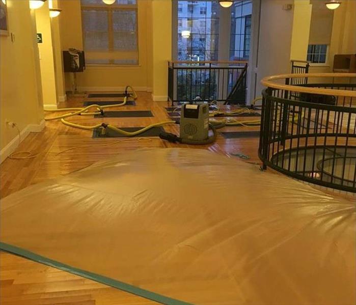 during the water damage restoration process, drying out the hardwood floors 