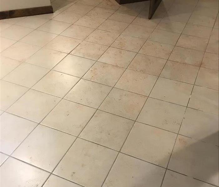 dirty tile floor with boot marks