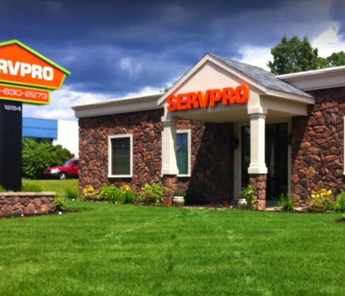 Front of SERVPRO of Meriden building and grass lawn, with SERVPRO sign on the left 