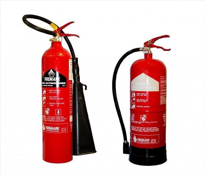 2 different red fire extinguishers side by side