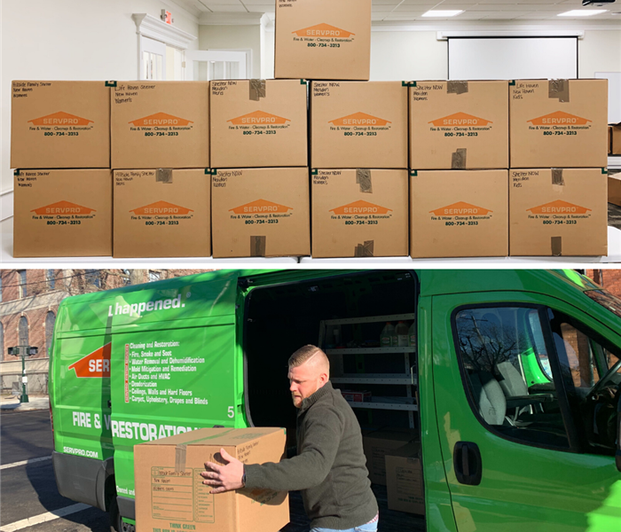 boxes of donations for local shelters; servpro marketer unloading servpro van to drop off donations